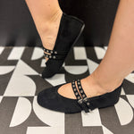 Black faux suede square toe flats with double buckle straps and silver-tone hardware.