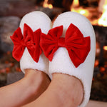 White closed-toe slippers with red bow accent, soft plush material, perfect for cozy lounging