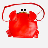Cherry red crab shaped crossbody bag with claw details and kiss lock closure.