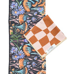 Crae Dandy/Dune towel set with floral black hand towel and brown checkerboard washcloth, gift-ready.