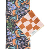 Crae Dandy/Dune towel set with floral black hand towel and brown checkerboard washcloth, gift-ready.