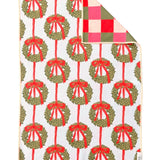 Crae reversible hand towel with green Christmas wreaths, red bows, and colorful checkered backing.