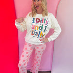 Cream sweatshirt with colorful sewn-on I Dilly And I Dally sequin graphic.