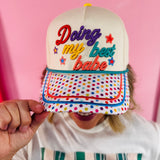 Cream hat with rainbow polka dot bill and colorful Doing My Best Babe embroidery.