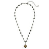 Gold-tone necklace with black diamond accents and black clover pendant, adjustable 16–18 inch length.