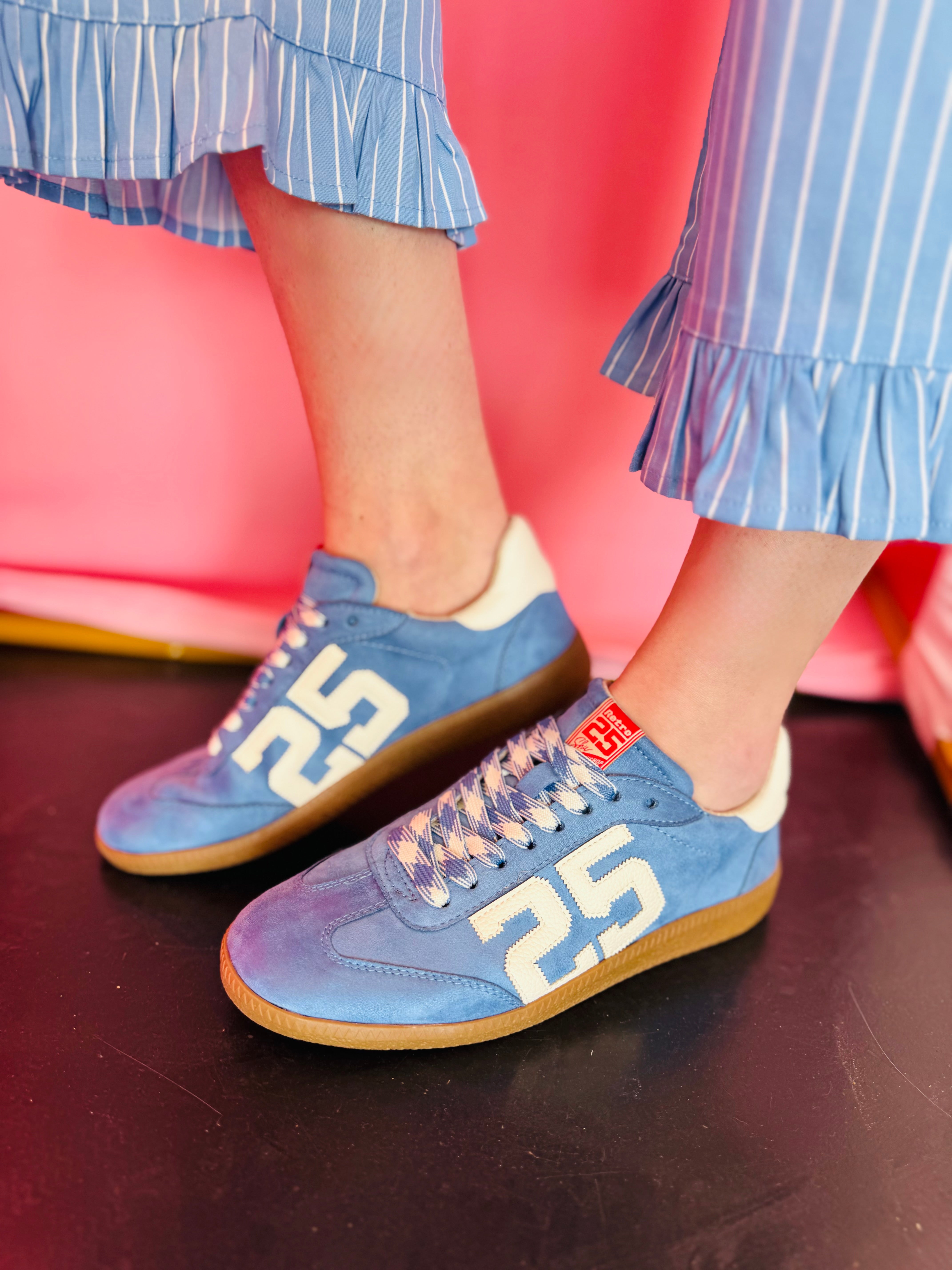 Sky-blue suede Retro 25 sneakers with cream accents, stitched detail, and gum sole.