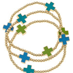 Green, turquoise, and blue stretch bracelets with enamel crosses and gold beads.