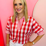 Red and white gingham top with striped collar, rolled sleeves, and hi-low hem.
