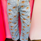 Football print barrel jogger pants with drawstring waist and star accents.