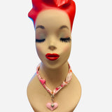 Pink and ivory floral scarf necklace with puffy pink heart charm and silver heart charm, tied in a stylish knot and designed to be worn as a necklace, bracelet, or accessory.