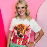 Cream Highland cow graphic tee with pink polka dot suit and crystal details.