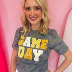 Gold Game Day tee with patchwork appliqué lettering and mixed gold print details.