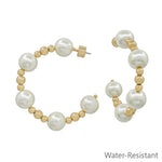 Water resistant gold hoop earrings with 10mm pearl beads in a 2-inch dangle design.
