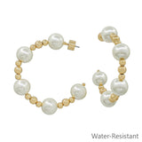 Water resistant gold hoop earrings with 10mm pearl beads in a 2-inch dangle design.