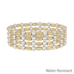 Gold and silver textured bracelet stack with mixed metal beads and water-resistant design.
