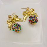 Gold bow drop earrings with confetti textured charm, lightweight and elegant