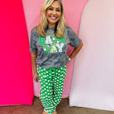 Green and white polka dot cropped barrel pants with drawstring waist and pockets.