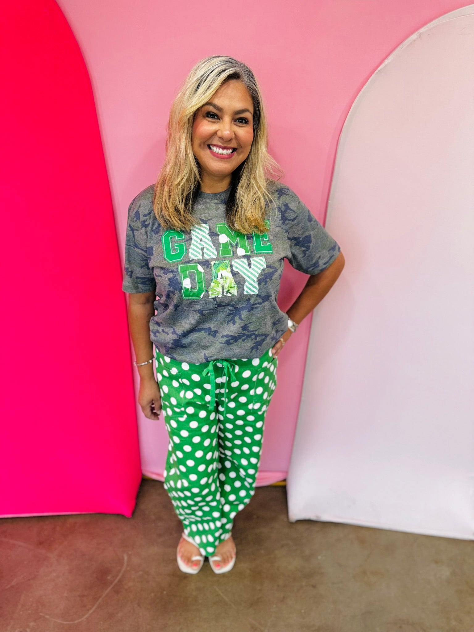 Green and white polka dot cropped barrel pants with drawstring waist and pockets.