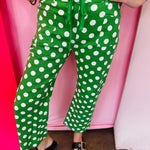 Green and white polka dot cropped barrel pants with drawstring waist and pockets.