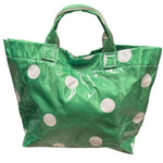 Green polka dot tote bag with shiny finish and white dots.