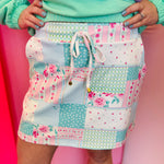 Mint patchwork skort with pastel floral panels, drawstring waist, built-in shorts, and side pockets