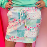Mint patchwork skort with pastel floral panels, drawstring waist, built-in shorts, and side pockets