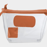 Jon Hart Airport Chico clear TSA-compliant travel pouch with orange Natural Leather trim, flat bottom, and zippered brass closure—perfect for carrying 3oz liquids and travel essentials.