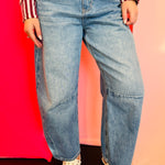 Dark wash high-waisted barrel jeans with wide legs and darted knee detailing