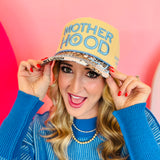 Motherhood hat with tan crown, corduroy details, leopard bill, and “raising wild things” embroidery.