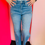 High-rise wide-leg jeans with rhinestone bow embellishments.