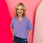 Lavender collared V-neck airflow top with short sleeves and a soft, lightweight drape.