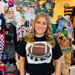 ootball tee with oversized black and clear rhinestone crystals and football graphic details.