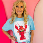Blue collared tee with white lobster patch and short sleeves.