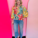 Striped colorblock floral peplum top with puff sleeves and front bow tie detail.