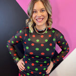 Black sheer mesh top with red and green Christmas polka dots and mock neckline.