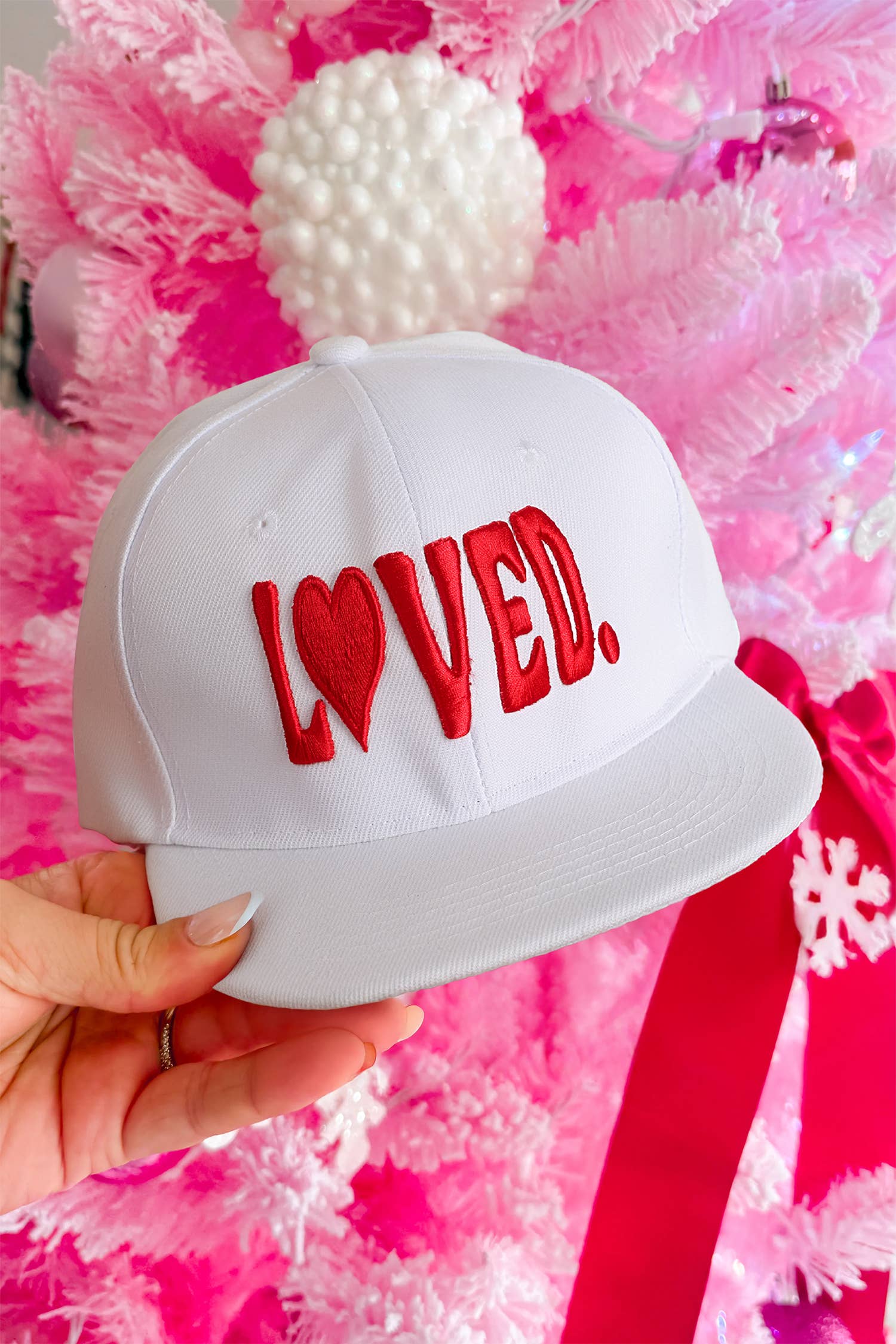 White LOVED embroidered baseball cap with heart detail and adjustable snapback closure