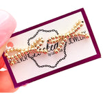 Gold filled bow earrings with delicate hand-beaded design.