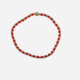 Gold filled bracelet with red beads, pearl accents, and stretch fit.