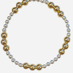 Mixed metal bracelet with gold and silver beaded waterproof design.