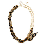 Leopard print scarf necklace with gold chain and adjustable length.