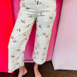 Beige cuffed pants with allover mallard duck print and relaxed fit