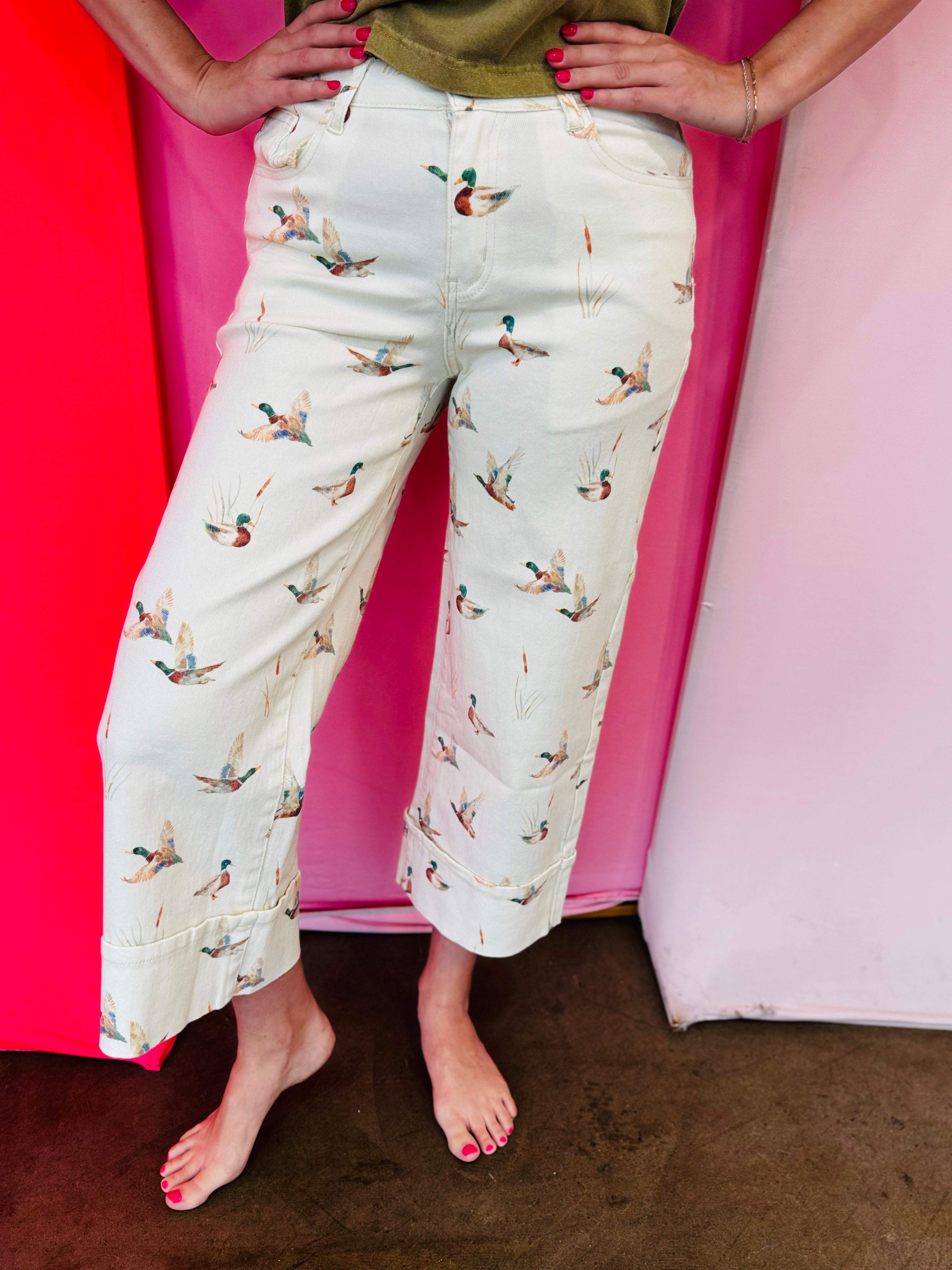 Beige cuffed pants with allover mallard duck print and relaxed fit