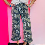 Camo wide leg cropped jeans with high-rise fit and cuffed hem detail.
