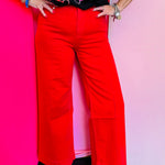 Red high-rise wide leg ankle jeans with structured waistband and flowy fit.