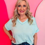 Mint corded rib knit top with relaxed fit and hi-low V-neck.