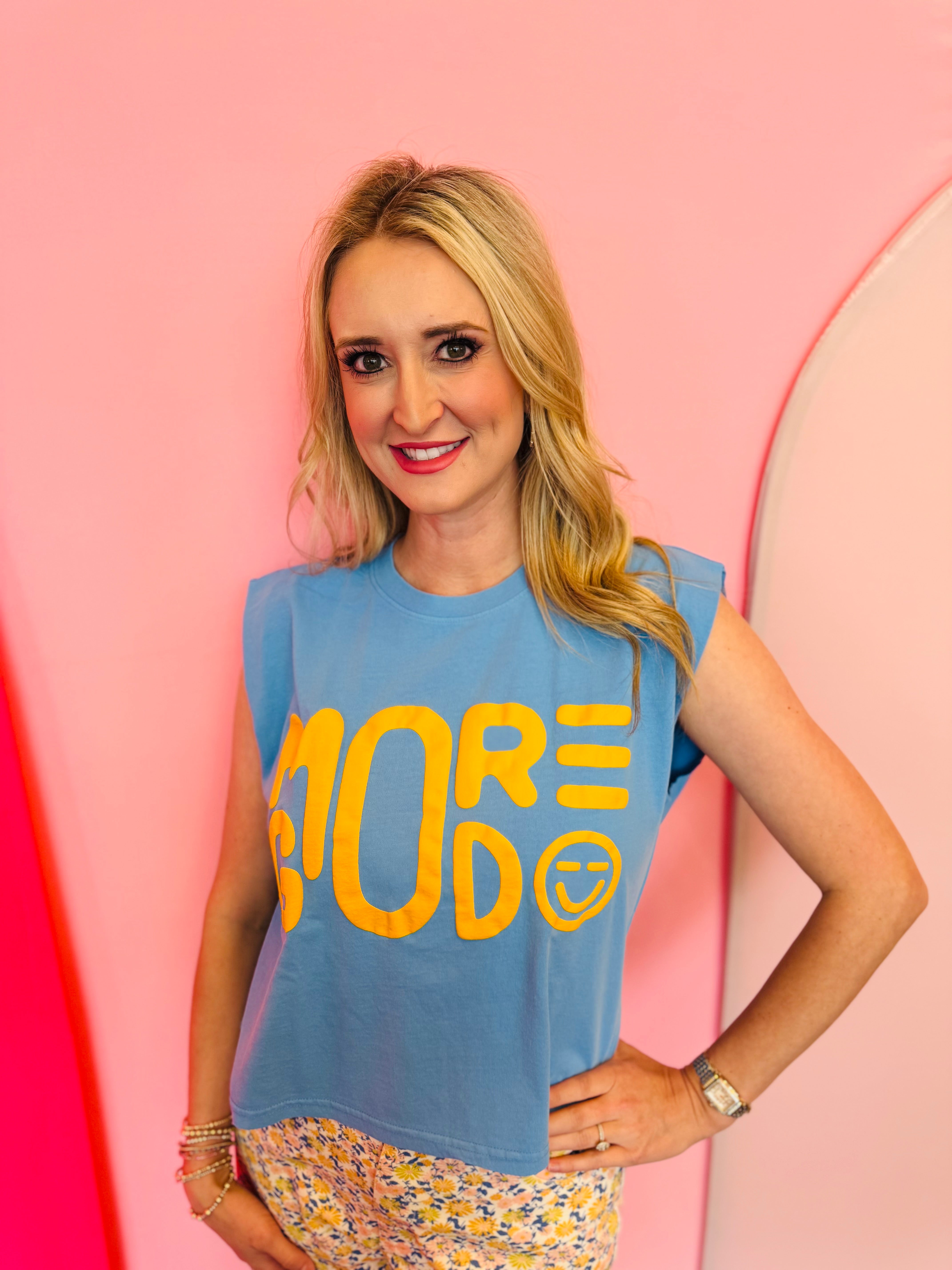 Dusty blue cropped muscle tank with yellow More God text and smiley face.