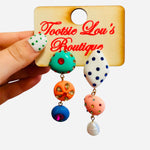 Colorful asymmetrical rhinestone earrings with pearl, mint, coral, blue, and pink details