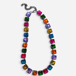 Multicolor necklace with oversized faceted crystals in pink, orange, yellow, green, blue, and purple.