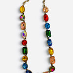 Multicolor jewel-tone crystal necklace with antique gold settings.