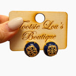 Navy and gold filigree stud earrings with elegant cutout detailing.